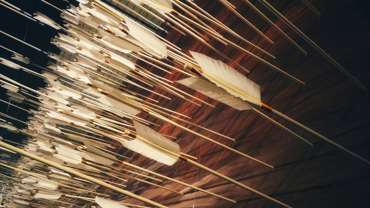 Recurve bow at full draw with a carbon arrow on the rest, illustrating recurve arrow spine selection for a finger shooter