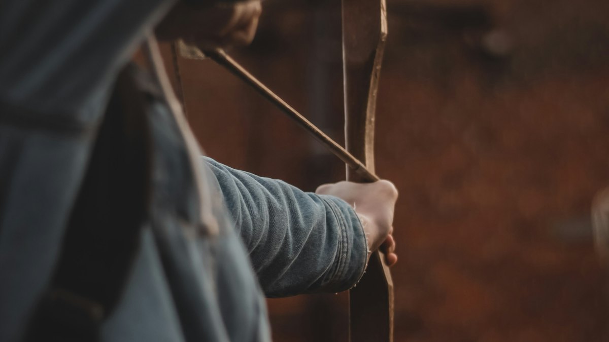Archers at full draw shooting budget carbon arrows from import and house brands